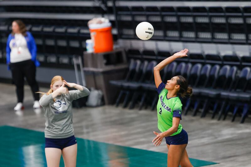 The Ridgeline Riverhawks’ Nia Damuni (wearing green) hits the ball