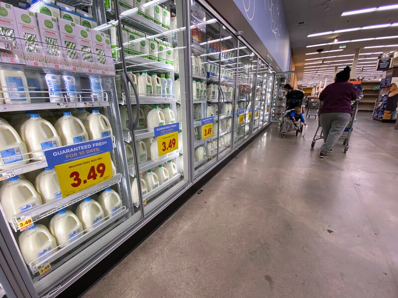 Shoppers browse for items in the dairy section of a local grocery store in Salt Lake City.