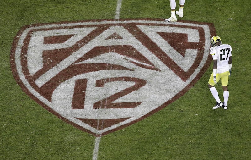 Oregon defensive back Terrance Mitchell (27) walks next to a Pac-12 logo on the field at Stanford Stadium during an NCAA college football game against Stanford in Stanford, Calif., Thursday, Nov. 7, 2013. (AP Photo/Jeff Chiu)