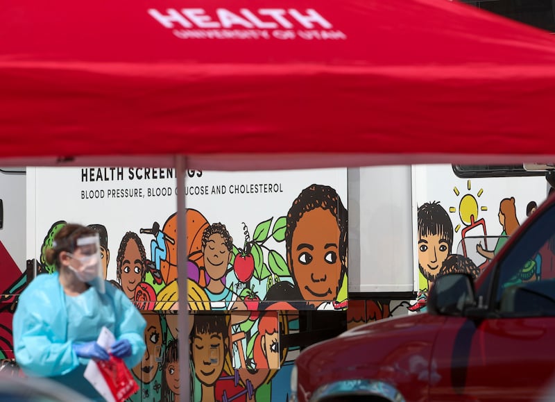 Medical assistants with University of Utah Health test people for COVID-19 during a drive-thru testing event at Centro Cívico Mexicano in Salt Lake City on Friday, May 15, 2020. The Consulate of Mexico in Salt Lake City, in collaboration with the Utah Department of Health, the University of Utah Wellness Bus, the Salt Lake County Health Department and Comunidades Unidas, organized the free testing for people with no insurance. Organizers hoped to test 100 people.