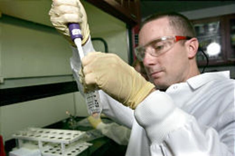 Dennis Cook analyzes tissue samples from Asia at Sorenson Genomics laboratory in Salt Lake City.