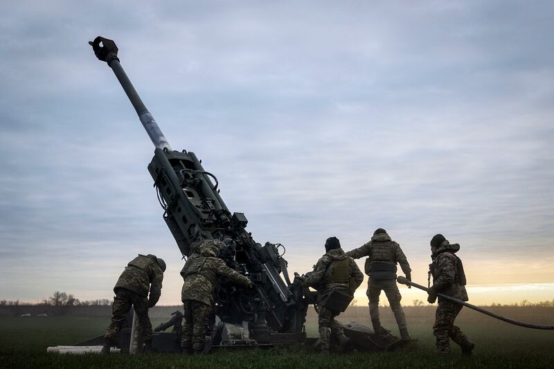 Ukrainian soldiers prepare a U.S.-supplied M777 howitzer to fire at Russian positions in Kherson, Ukraine, Jan. 9, 2023.