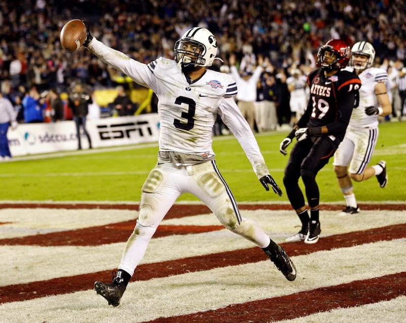 BYU linebacker Kyle Van Noy holds out the ball as he scores on a 17-yard interception return during the Poinsettia Bowl against San Diego State, Thursday, Dec. 20, 2012, in San Diego.