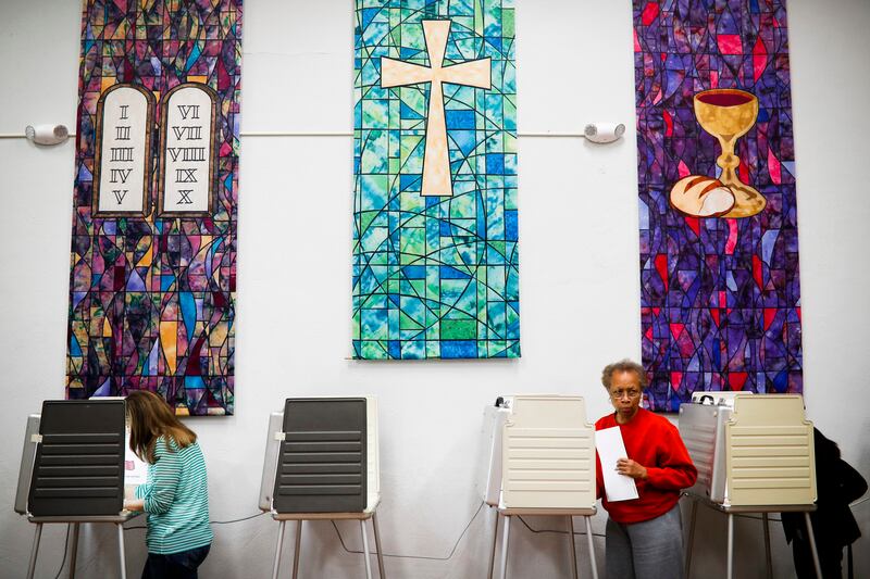 Virgina Price steps away from a voting booth after filling out her ballot at a polling place inside the Pleasant Ridge Presbyterian Church on Election Day, Tuesday, Nov. 8, 2016, in Cincinnati. Beyond serving as polling places, houses of worship support s