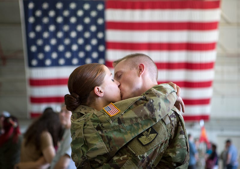 2nd Lt. Corinne Galland kisses her husband, 1st Lt. Colter Bowman, before his deployment to the Middle East with approximately 100 Utah National Guard soldiers at the Roland R. Wright Air National Guard Base in Salt Lake City on Monday, June 4, 2018.