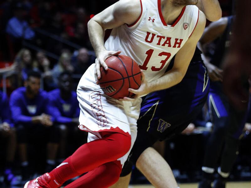 Utah Utes forward David Collette (13) drives to the basket with Washington Huskies forward Sam Timmins (33) defending during NCAA basketball in Salt Lake City on Saturday, Feb. 11, 2017.