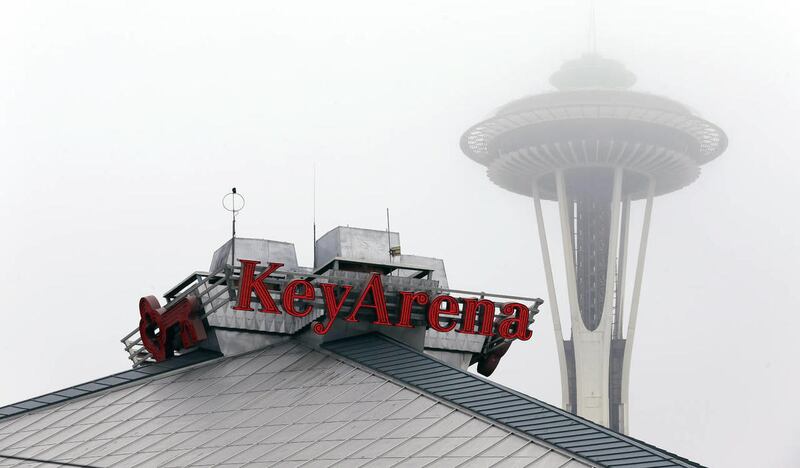 A sign for KeyArena appears near the Space Needle, Monday, Jan. 21, 2013, in Seattle. KeyArena would host NBA basketball games for two seasons if a team returns to Seattle as was reported likely on Monday, while a new permanent facility is built south of