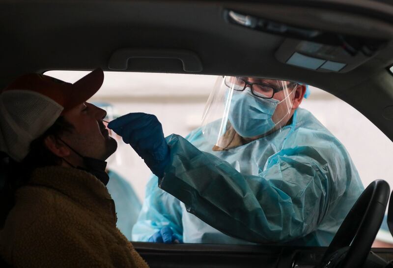Utah National Guard soldier Ebbin Wyatt administers a COVID-19 test to Nick Bradley at the Utah State Fairpark in Salt Lake City.
