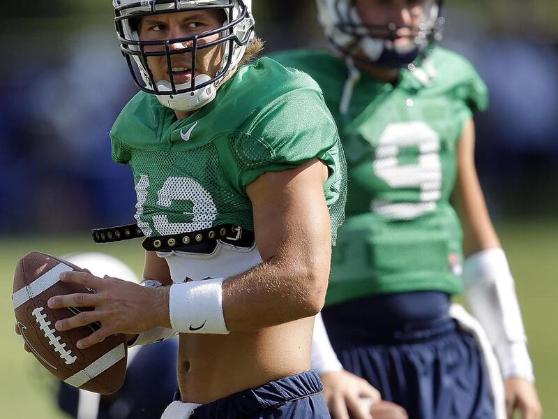 Quarterbacks' Riley Nelson,left, and #9 Jake Heaps workout during BYU football practice Monday, Aug. 15, 2011.