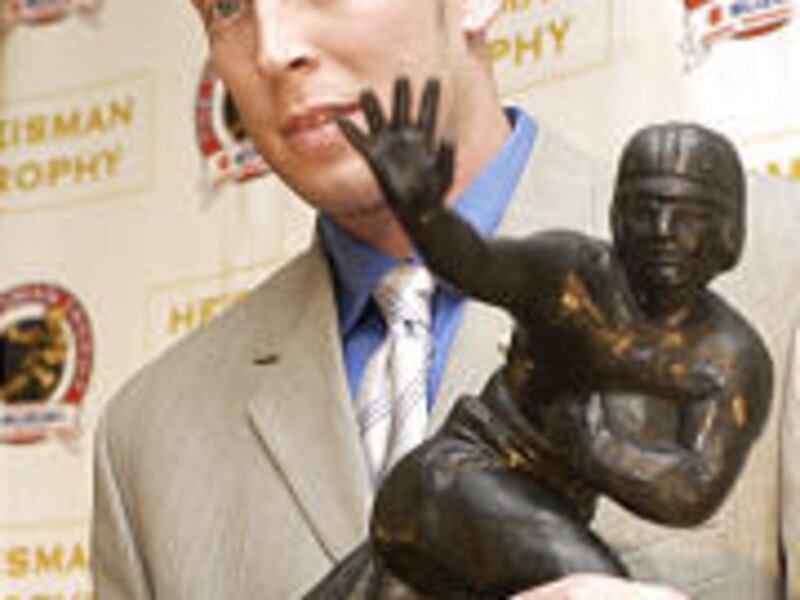 2003 Heisman Trophy winner Jason White, a quarterback from Oklahoma, poses with award.