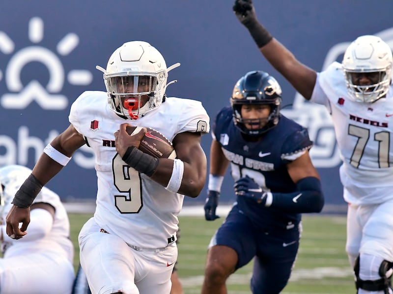UNLV running back Aidan Robbins (9) carries the ball down the field during an NCAA college football game against Utah State.