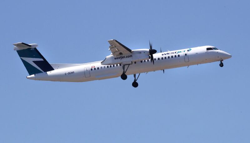 A WestJet airlines passenger plane, a De Havilland DHC-8-400 model, approaches Logan Airport in Boston, Thursday, May 24, 2018.
