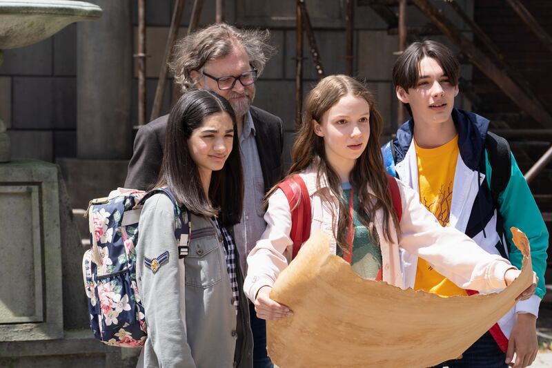 Ruby O’Reilly (Zoe Wiesenthal) holds a map while surrounded by her friends in “Ruby and the Well.”