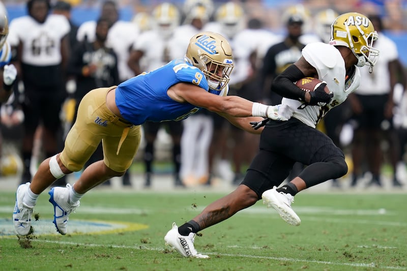 UCLA linebacker Choe Bryant-Strother (9) tackles Alabama State wide receiver Isaiah Scott (84) during the first half of an NCAA college football game in Pasadena, Calif., Saturday, Sept. 10, 2022.
