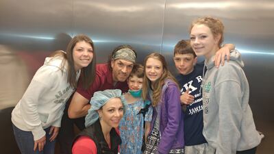 Gage Bingham (middle) is the most recent of the Bingham children to have a heart transplant. He is pictured with his family on April 5, 2017.