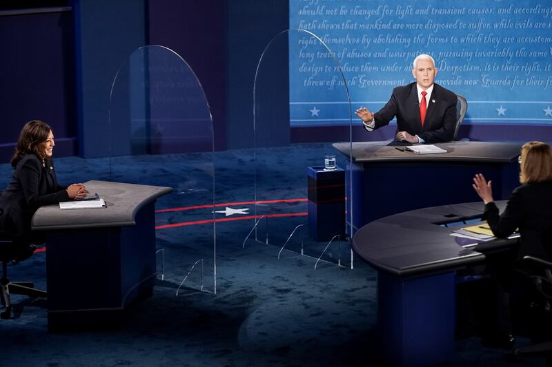 Moderator Susan Page tries to reign in Vice President Mike Pence as he talks past his allotted time during his debate against Democratic challenger Sen. Kamala Harris, D-Calif., in the vice presidential debate at Kingsbury Hall at the University of Utah in Salt Lake City on Wednesday, Oct. 7, 2020.