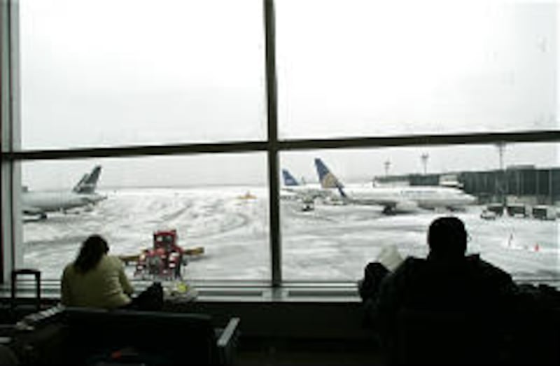 Passengers wait out the storm at La Guardia airport in New York. At JFK airport, passengers were stuck overnight on planes that couldn't take off.