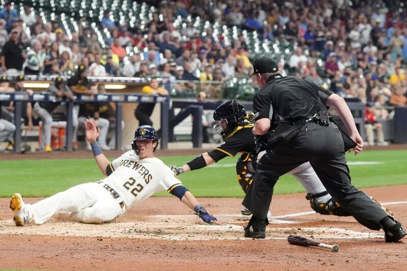 Pittsburgh Pirates catcher Jason Delay tags out Milwaukee Brewers’ Christian Yelich during the third inning of an Aug. 29, 2022, game in Milwaukee.
