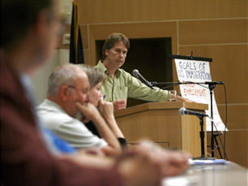 Jeff Nielsen, standing, conducts a panel discussion about immigration at the Salt Lake Main Library on Sunday.
