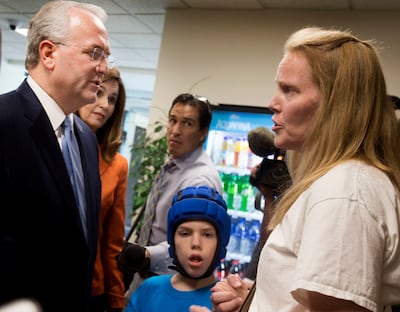 Elder Jack N. Gerard, a General Authority Seventy of The Church of Jesus Christ of Latter-day Saints, speaks with Heather Nelson and her son, Matthew, 10, after a press conference at the Utah State Office Building in Salt Lake City on Thursday, Aug. 23, 2