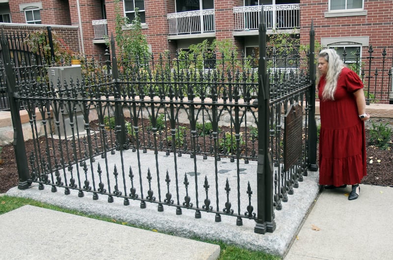 A guest looks at Brigham Young’s gravesite at the Brigham Young Family Cemetery in Salt Lake City on Oct. 22, 2022.