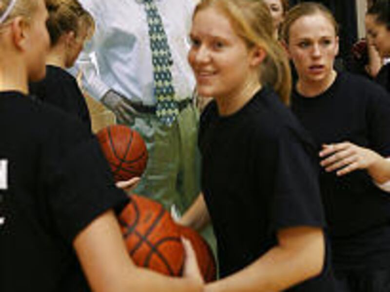 Mountain View basketball players show support of former coach Dave Houle by bringing a cutout of him into the gym at a game last week.