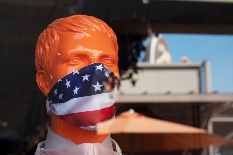 In this Thursday, July 2, 2020 file photo, a mannequin wears a face mask in the window of a store in Commerce, Calif. On Friday, July 10, 2020, The Associated Press reported on stories circulating online incorrectly asserting that wearing a face mask for extended periods of time can cause pleurisy, an inflammation of the lining around the lung. Multiple experts told The Associated Press there is no medical evidence that wearing a face mask could lead to this condition.