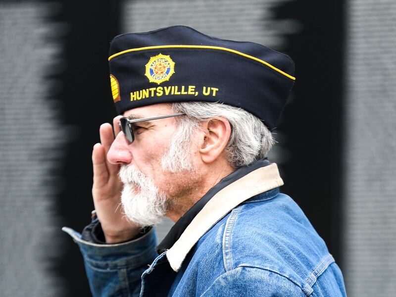 A veteran salutes while taps is played during an event for National Vietnam Veterans Day in Layton on March 29, 2021.