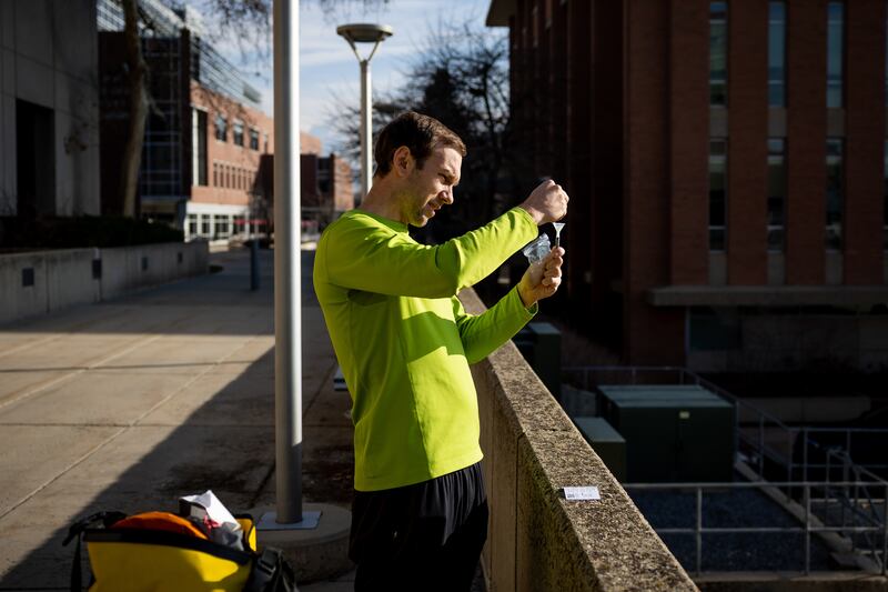 David Dorsey, an ICU doctor at the University of Utah Hospital, takes a self-administered COVID-19 test that he got out of a vending machine at the Eccles Health Sciences Library on the University of Utah campus in Salt Lake City.