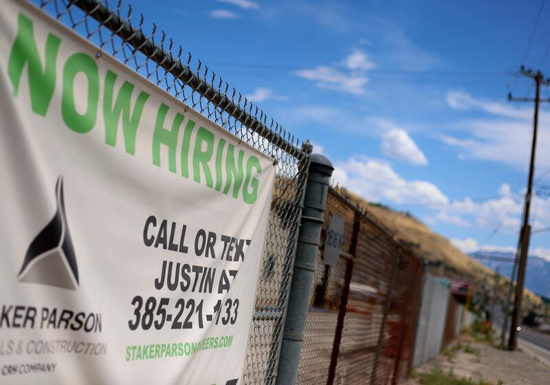 A “Now Hiring” sign is pictured outside Staker Parson in Salt Lake City on July 13, 2022.