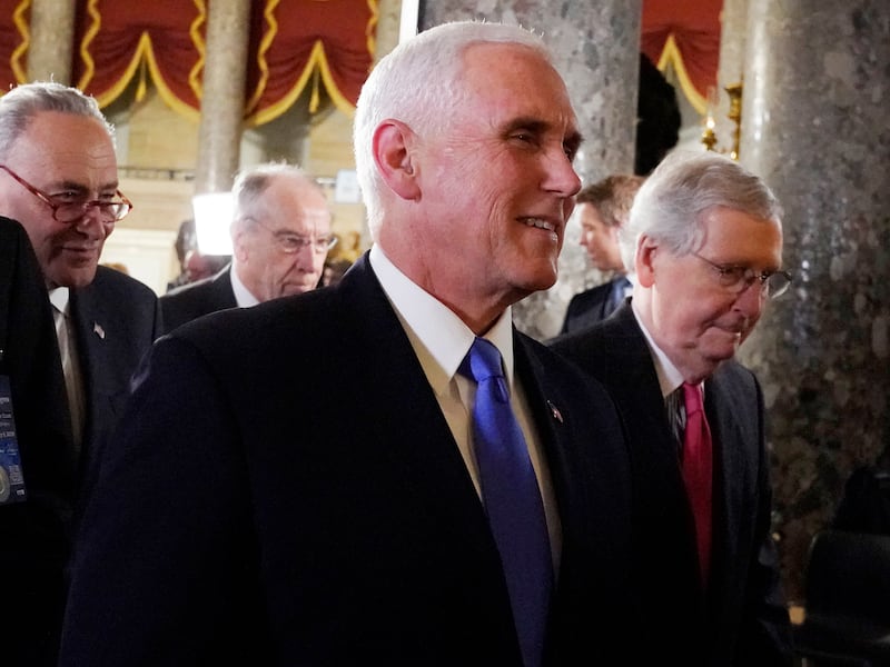 Vice President Mike Pence walks with Senate Majority Leader Mitch McConnell, right, and Senate Minority Leader Chuck Schumer, left and Sen. Chuck Grassley, R-Iowa, center rear, to listen to President Donald Trump deliver his State of the Union address to