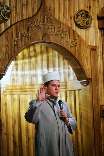 Imam Amir Salihovic of the Islamic Bosnian Mosque talks to visitors as they take part in the Interfaith Month bus tour on Tuesday, Feb. 27, 2018.