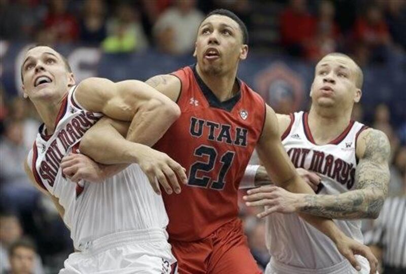 Utah forward Jordan Loveridge (21) battles for a rebound against  St. Mary's forward Beau Levesque, left, and guard Kerry Carter, right, during the first half of an NCAA college basketball game against Utah in the first round of the National Invitational