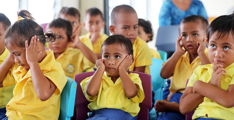 Seu Tialino, center, sings and makes motions during an activity at Foundational Learning preschool at the Siumu Ward in Siumu, Samoa, on Thursday, May 16, 2019.
