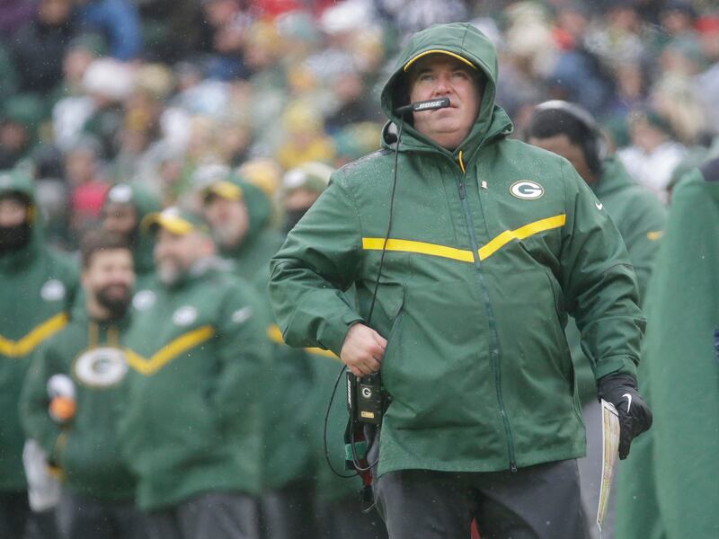 Green Bay Packers' Head Coach Mike McCarthy watches a replay on the scoreboard during the first half of an NFL football game against the Arizona Cardinals Sunday, Dec. 2, 2018, in Green Bay, Wis. (AP Photo/Mike Roemer)