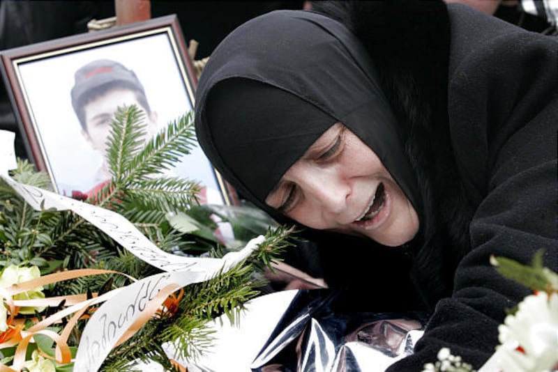 Dodo, mother of Nodar Kumaritashvili, the Georgian luger killed in a practice run at the Olympics, mourns over his grave in Bakuriani, Georgia, Tuesday during a ceremony in honor of Nodar Kumaritashvili.