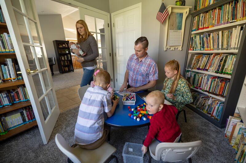 Emily Arnott, and her husband, Isaac, play with their children a their home in Springville, Utah, on Friday, Oct. 1, 2021. The 2021 American Family Survey examines family life, relationships and attitudes.