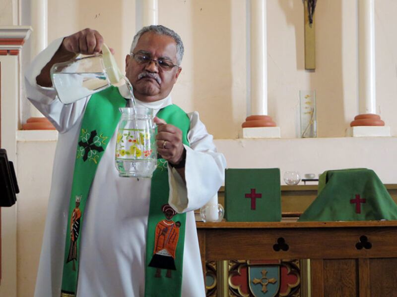 The Anglican bishop of Table Bay, the Rt. Rev. Garth Q. Counsell, slowly pours one pitcher of water into another before beginning his sermon at Zonnebloem Estate's chapel during the Anglican Diocese of Cape Town’s Water (In)Justice Conference on Feb. 3, 2