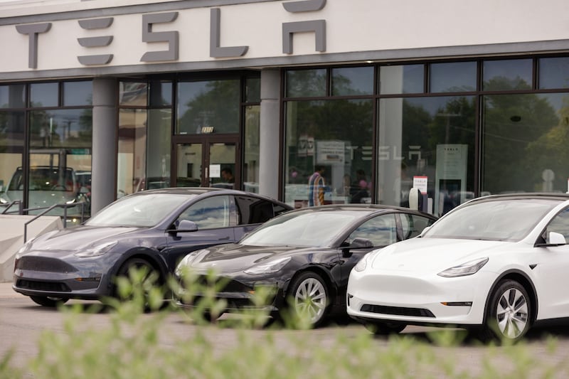 A row of Teslas sit parked outside a Tesla dealership in Provo on July 12, 2022.