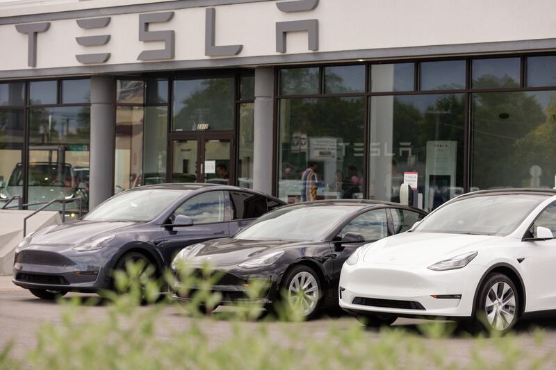A row of Teslas sit parked outside a Tesla dealership in Provo on July 12, 2022.