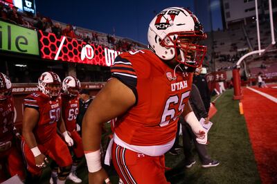 Utah Utes offensive lineman Paul Toala (65) and other players take to the field to warm up before the game against the Arizona Wildcats at Rice-Eccles Stadium in Salt Lake City on Friday, Oct. 12, 2018.