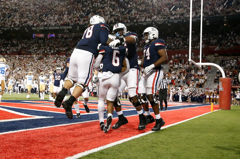 Arizona running back Michael Wiley (6) celebrates with teammates after scoring a TD during game vs. UCLA, Oct. 9, 2021.