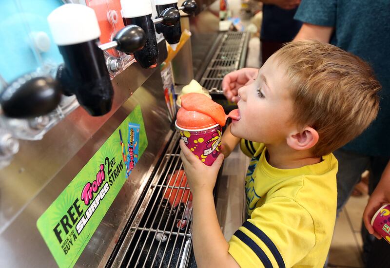 Tristan Jordan licks his overflowing Slurpee during 7-Eleven Day at 7-Eleven in Lehi on Tuesday, July 11, 2017. This particular 7-Eleven also hosted a blood drive with the Red Cross for 7-Eleven Day.