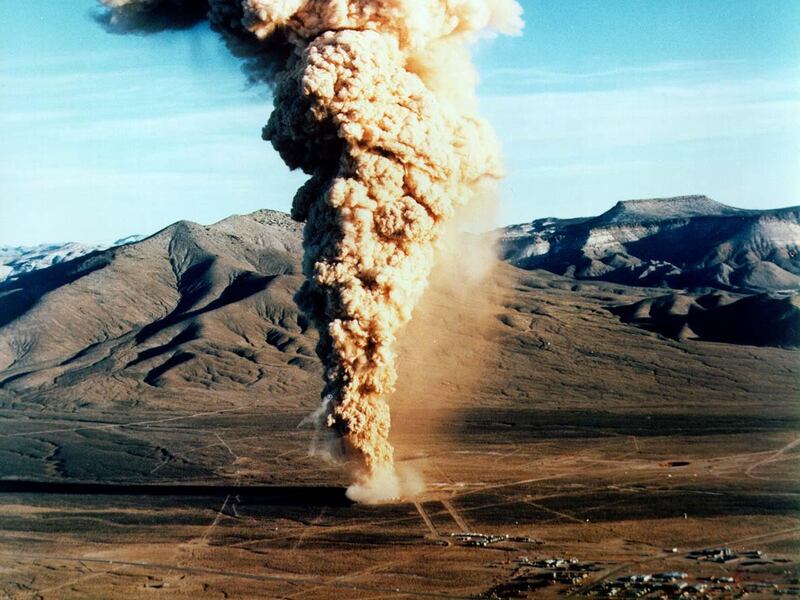 A plume of smoke rises from the Nevada Test Site after an underground explosion in 1970.