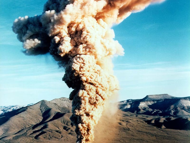A plume of smoke rises from the Nevada Test Site after an underground explosion in 1970.