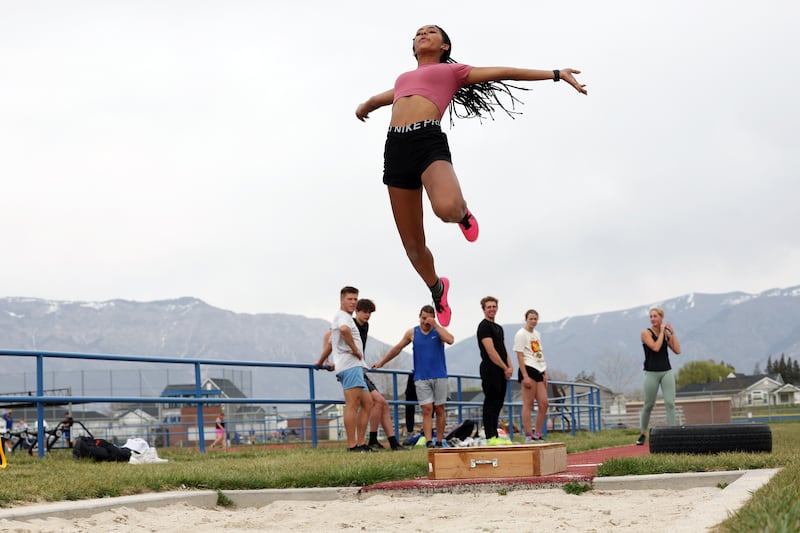 Fremont sprinter Amare Harlan jumps into the air on the long jump as she works out with the track team after school.