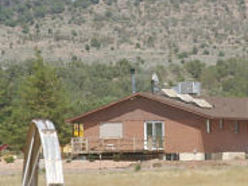 A helicopter drops water onto a hot spot in the Dammeron Complex Fire in Washington County Thursday.