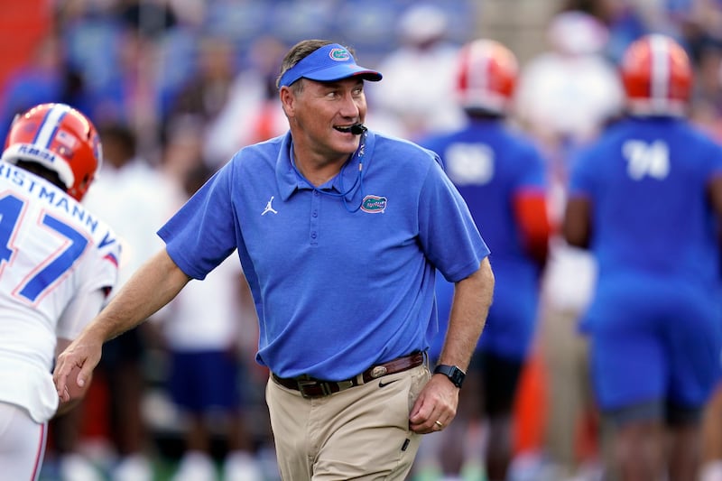 Florida head coach Dan Mullen watches players warm up before an NCAA college football game.