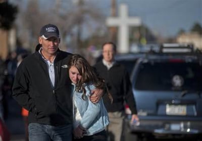 Sydney Barton and her dad Randal walk to their car after a school shooting at Arapahoe High School, where Sydney was a student, in suburban Denver in December 2013.