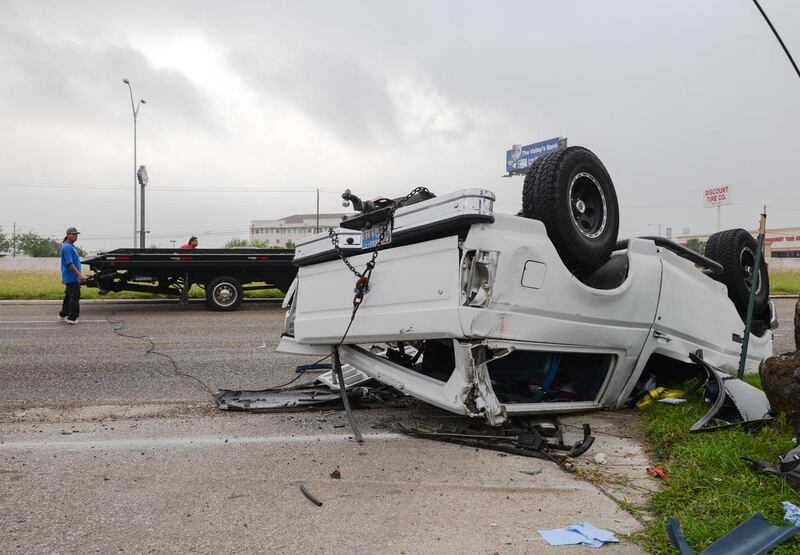 FILE - In this April 28, 2016 file photo, a wrecker crew prepares to flip over a Ford Bronco that was involved in an accident in Brownsville, Texas. Traffic fatalities were up 9 percent in the first six months of this year compared to the same period last